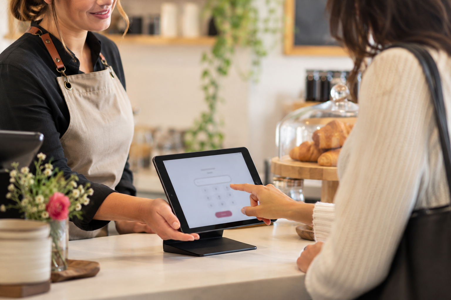 A customer entering their phone number on the counter tablet