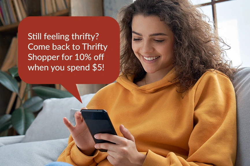A shopper reading a Thrifty Shopper offer at home