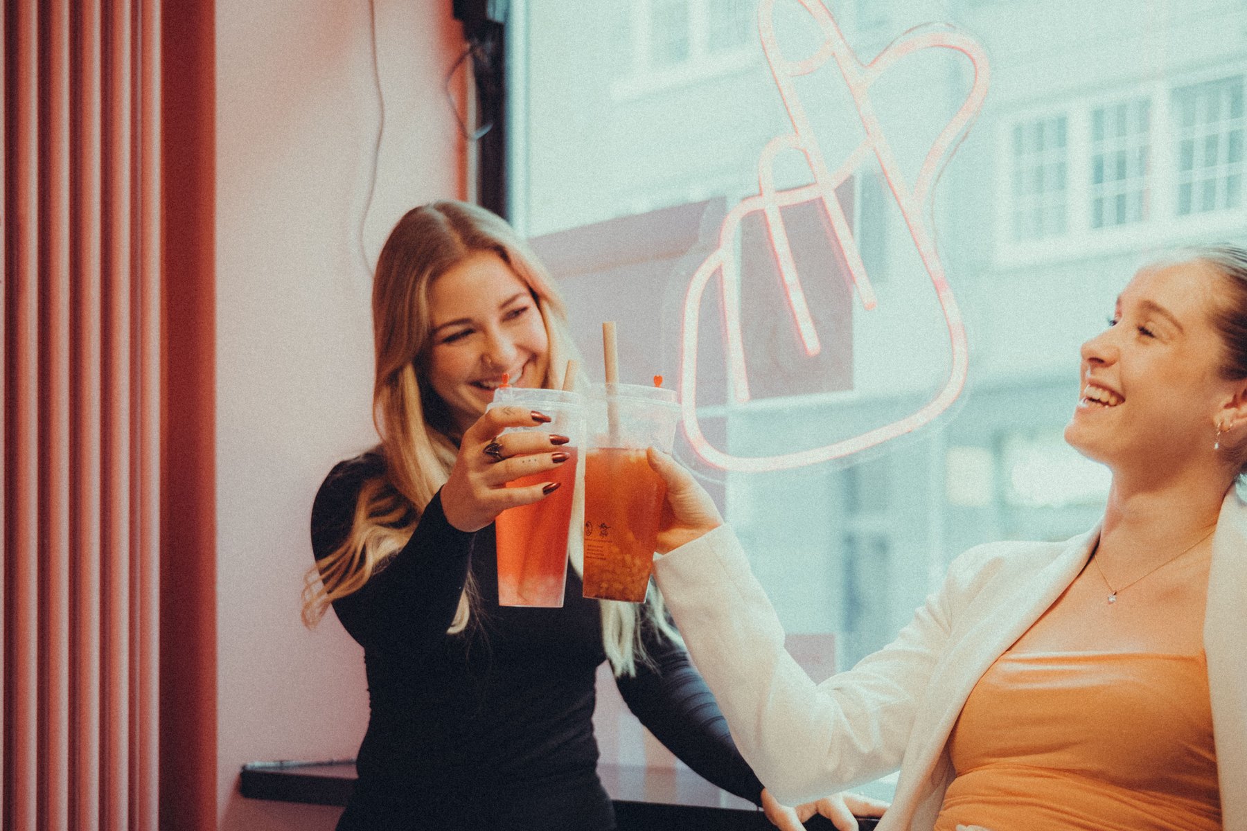 Two friends enjoying drinks they earned through the program