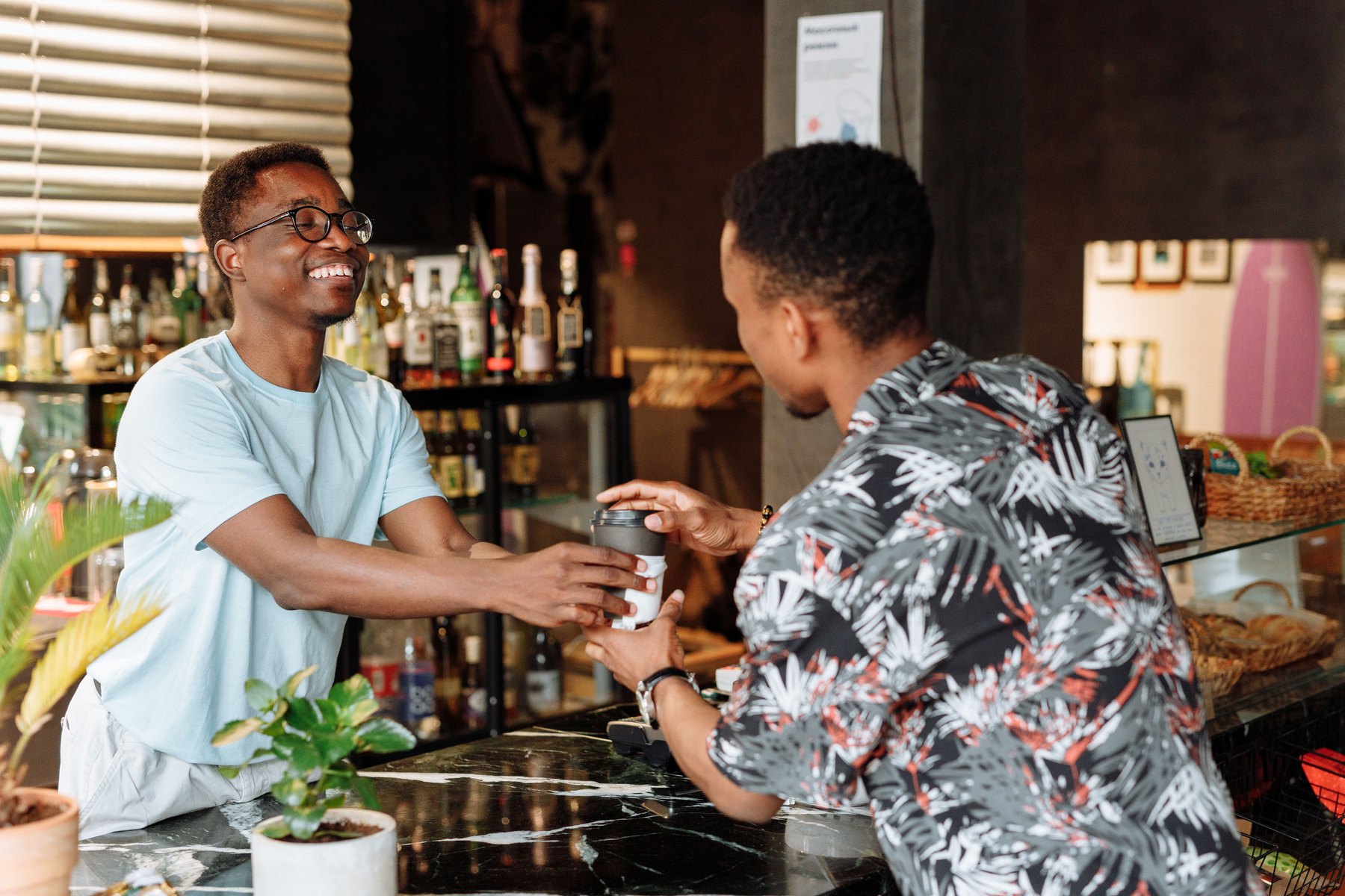 A barista greeting a regular by name